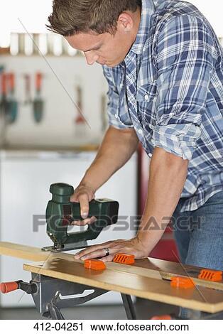Man working in workshop View Large Photo Image Stock Image - Man working in workshop. Fotosearch
