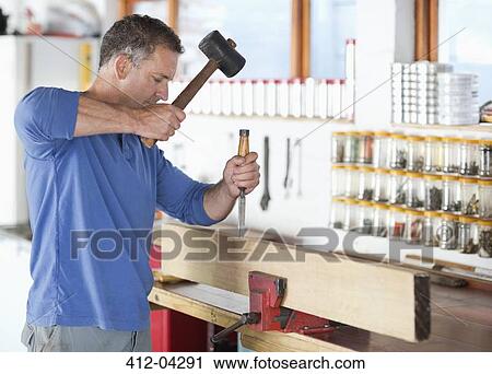 Man working in workshop View Large Photo Image Stock Image - Man working in workshop. Fotosearch