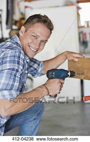 Man working in workshop View Large Photo Image Stock Photo - Man working in workshop. Fotosearch