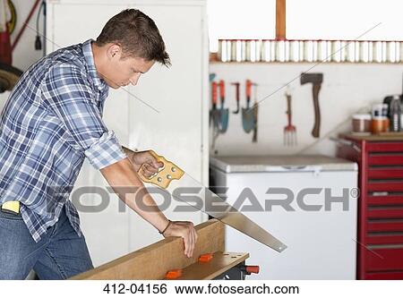Stock Photograph - Man working in workshop. Fotosearch