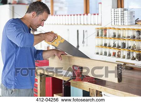 Man working in workshop View Large Photo Image Stock Photograph - Man working in workshop. Fotosearch