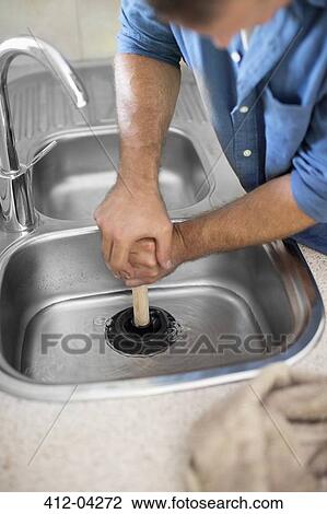 Plumber unclogging kitchen sink View Large Photo Image Stock Image - Plumber unclogging kitchen sink. Fotosearch