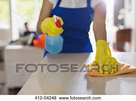 Woman cleaning kitchen counter View Large Photo Image Stock Photo - Woman cleaning kitchen counter. Fotosearch