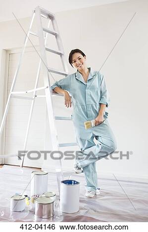 Woman smiling and painting room View Large Photo Image Stock Photograph - Woman smiling and painting room. Fotosearch