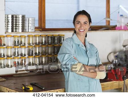 Woman smiling in workshop View Large Photo Image Picture - Woman smiling in workshop. Fotosearch