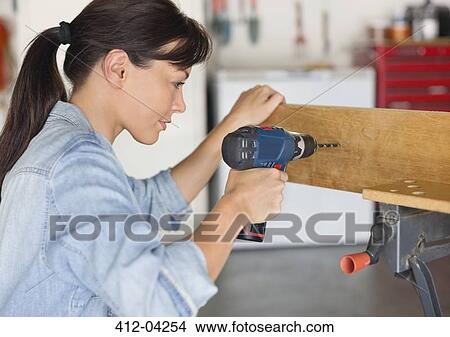 Woman working in workshop View Large Photo Image Picture - Woman working in workshop. Fotosearch
