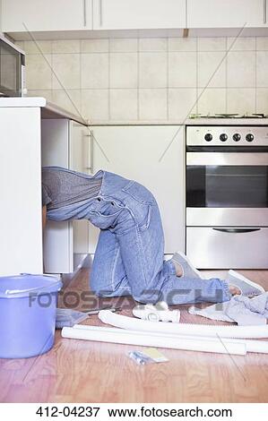 Woman working under kitchen sink View Large Photo Image Stock Photo - Woman working under kitchen sink. Fotosearch