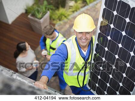 Worker installing solar panel on roof View Large Photo Image Picture - Worker installing solar panel on roof. Fotosearch