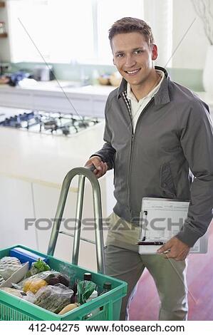 Worker with delivery in kitchen View Large Photo Image Stock Photography - Worker with delivery in kitchen. Fotosearch