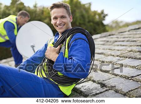 Workers installing satellite dish on roof View Large Photo Image Stock Photography - Workers installing satellite dish on roof. Fotosearch