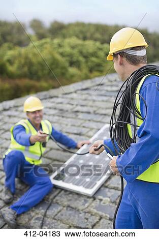 Workers installing solar panel on roof View Large Photo Image Stock Image - Workers installing solar panel on roof. Fotosearch
