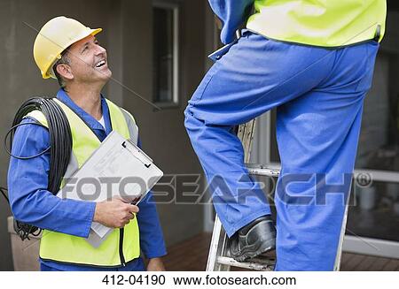 Workers talking on site View Large Photo Image Stock Image - Workers talking on site. Fotosearch