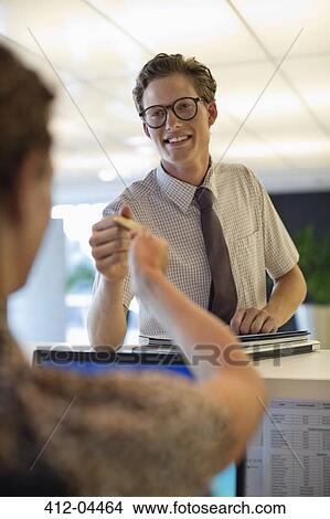 Business people exchanging cards in office View Large Photo Image Picture - Business people exchanging cards in office. Fotosearch