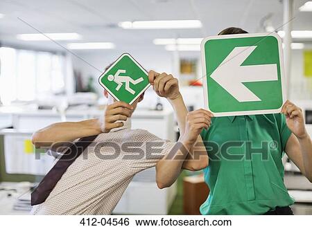 Business people holding signs in office View Large Photo Image Stock Photograph - Business people holding signs in office. Fotosearch
