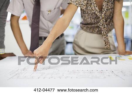Business people reading blueprints in meeting View Large Photo Image Stock Photo - Business people reading blueprints in meeting. Fotosearch