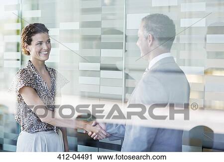 Business people shaking hands in office View Large Photo Image Stock Image - Business people shaking hands in office. Fotosearch