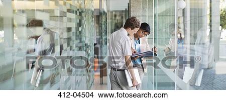 Picture - Business people talking in office. Fotosearch