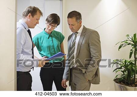Stock Image - Business people talking in office. Fotosearch