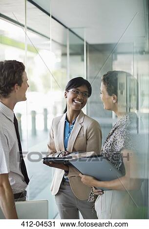 Stock Image - Business people talking in office. Fotosearch