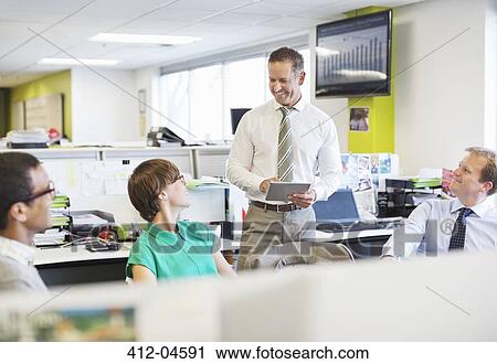 Stock Image - Business people talking in office. Fotosearch