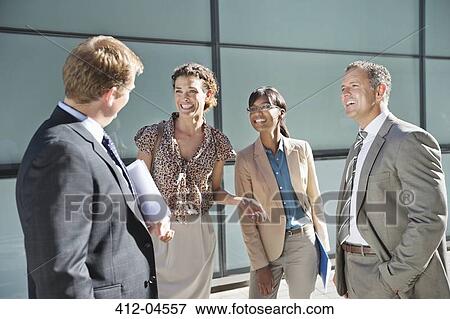Business people talking on city street View Large Photo Image Stock Photo - Business people talking on city street. Fotosearch