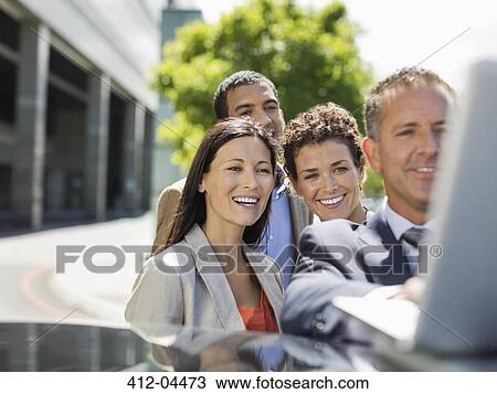 Business people using laptop outdoors View Large Photo Image Stock Image - Business people using laptop outdoors. Fotosearch