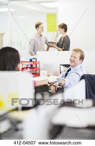 Stock Photo - Business people working together in office. Fotosearch
