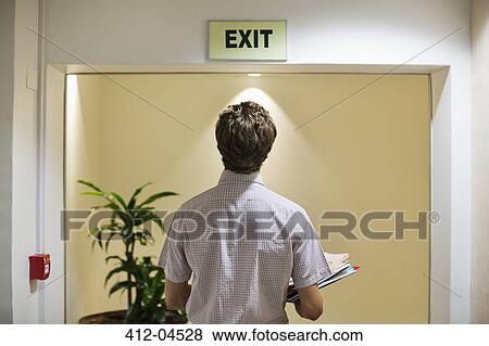 Businessman examining? exit? sign in offic View Large Photo Image Stock Photo - Businessman examining? exit? sign in offic. Fotosearch