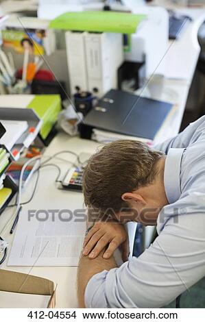Businessman resting head on desk View Large Photo Image Picture - Businessman resting head on desk. Fotosearch