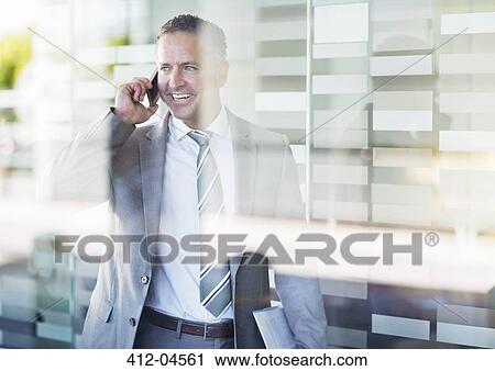 Businessman talking on cell phone View Large Photo Image Stock Image - Businessman talking on cell phone. Fotosearch