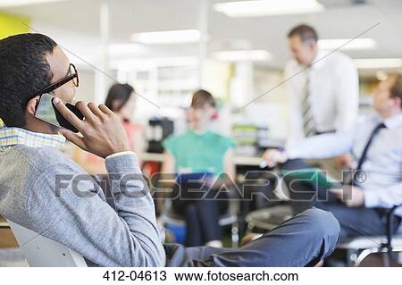 Stock Image - Businessman talking on cell phone. Fotosearch