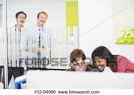 Businessmen eavesdropping on colleagues View Large Photo Image Stock Image - Businessmen eavesdropping on colleagues. Fotosearch