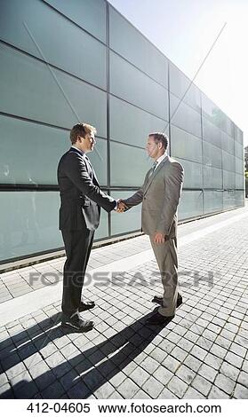 Businessmen shaking hands on city street View Large Photo Image Stock Photography - Businessmen shaking hands on city street. Fotosearch
