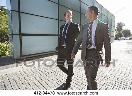 Stock Photo - Businessmen talking on city street. Fotosearch