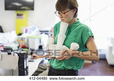 Businesswoman balancing empty coffee cups View Large Photo Image Stock Photography - Businesswoman balancing empty coffee cups. Fotosearch