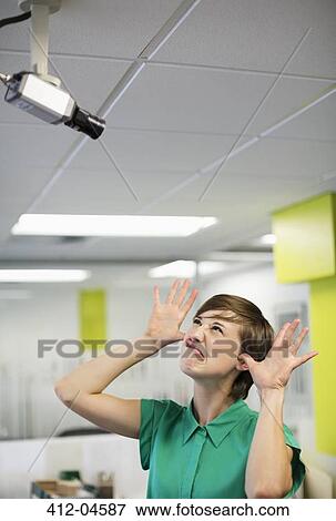 Businesswoman making face at security camera View Large Photo Image Stock Photo - Businesswoman making face at security camera. Fotosearch