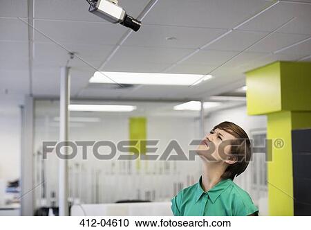 Businesswoman making faces at security camera View Large Photo Image Stock Image - Businesswoman making faces at security camera. Fotosearch