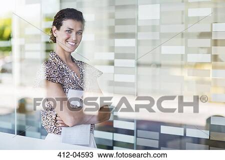 Businesswoman smiling in office View Large Photo Image Stock Image - Businesswoman smiling in office. Fotosearch