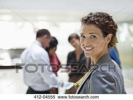 Businesswoman smiling in office View Large Photo Image Stock Photography - Businesswoman smiling in office. Fotosearch