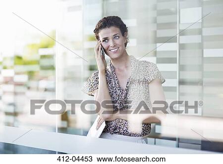 Businesswoman talking on cell phone View Large Photo Image Stock Image - Businesswoman talking on cell phone. Fotosearch