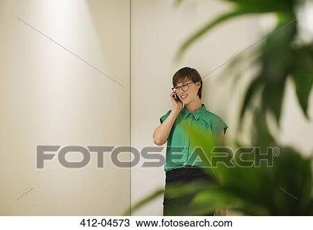 Stock Image - Businesswoman talking on cell phone. Fotosearch