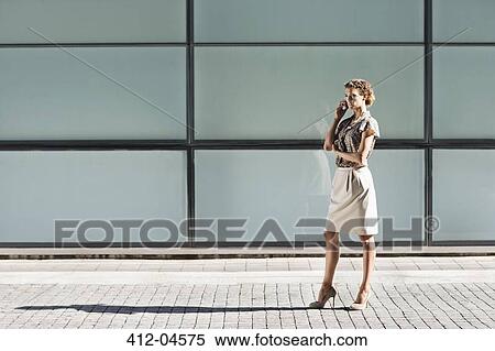 Businesswoman talking on cell phone View Large Photo Image Stock Photography - Businesswoman talking on cell phone. Fotosearch