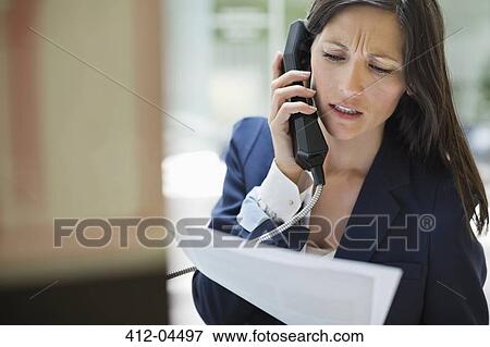 Businesswoman talking on phone in office View Large Photo Image Stock Photo - Businesswoman talking on phone in office. Fotosearch