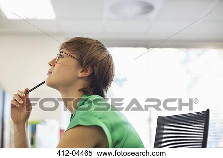 Businesswoman thinking at desk View Large Photo Image Stock Photography - Businesswoman thinking at desk. Fotosearch