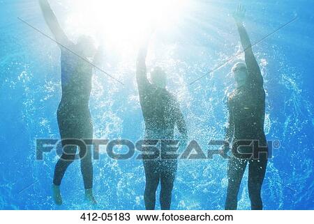 Stock Image - Athletes swimming underwater. Fotosearch