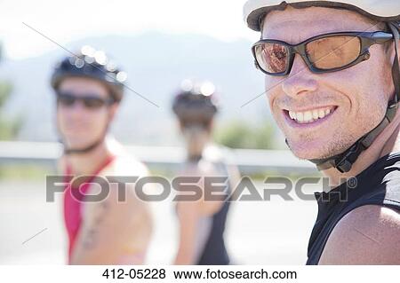 Cyclist smiling on rural road View Large Photo Image Stock Photo - Cyclist smiling on rural road. Fotosearch