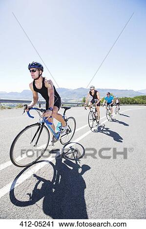 Cyclists in race on rural road View Large Photo Image Stock Image - Cyclists in race on rural road. Fotosearch