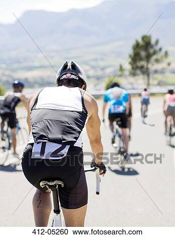 Cyclists in race on rural road View Large Photo Image Stock Image - Cyclists in race on rural road. Fotosearch