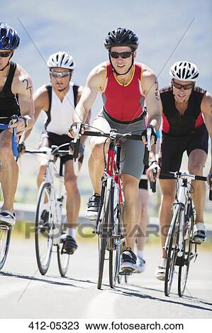 Cyclists in race on rural road View Large Photo Image Stock Image - Cyclists in race on rural road. Fotosearch