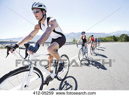 Cyclists in race on rural road View Large Photo Image Stock Photo - Cyclists in race on rural road. Fotosearch